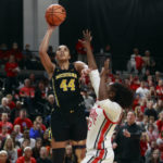 
              Michigan forward Cameron Williams, left, shoots in over Ohio State forward Eboni Walker during the first half of an NCAA college basketball game in Columbus, Ohio, Saturday, Dec. 31, 2022. (AP Photo/Paul Vernon)
            