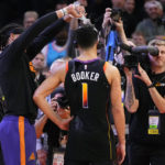 
              Phoenix Suns guard Devin Booker (1) has water poured on his head by teammate Damion Lee after an NBA basketball game against the New Orleans Pelicans, Saturday, Dec. 17, 2022, in Phoenix. The Suns defeated the Pelicans 118-114. (AP Photo/Matt York)
            