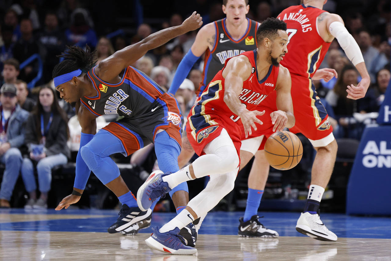 New Orleans Pelicans guard CJ McCollum, front right, drives the ball away from Oklahoma City Thunde...