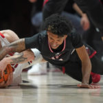 
              Utah guard Gabe Madsen, left, and Jacksonville State guard Cam McDowell reach for the ball during the second half of an NCAA college basketball game Thursday, Dec. 8, 2022, in Salt Lake City. (AP Photo/Rick Bowmer)
            