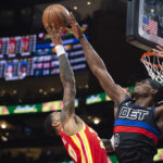 
              A shot by Atlanta Hawks forward John Collins is blocked by Detroit Pistons center Jalen Duren during the first half of an NBA basketball game Friday, Dec. 23, 2022, in Atlanta. (AP Photo/Hakim Wright Sr.)
            