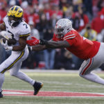 
              Michigan running back Donovan Edwards, left, turns up field past Ohio State defensive lineman Zach Harrison during the second half of an NCAA college football game on Saturday, Nov. 26, 2022, in Columbus, Ohio. (AP Photo/Jay LaPrete)
            