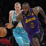 
              Los Angeles Lakers forward LeBron James (6) dribbles past Charlotte Hornets center Mason Plumlee during the first half of an NBA basketball game Friday, Dec. 23, 2022, in Los Angeles. (AP Photo/Marcio Jose Sanchez)
            
