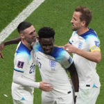 
              England's Bukayo Saka celebrates with England's Phil Foden, left, and England's Harry Kane after scoring his side's 3rd goal during the World Cup round of 16 soccer match between England and Senegal, at the Al Bayt Stadium in Al Khor, Qatar, Sunday, Dec. 4, 2022. (AP Photo/Ariel Schalit)
            
