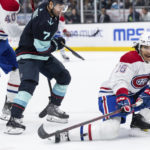 
              Montreal Canadiens defenseman Johnathan Kovacevic, right, knocks the puck away from Seattle Kraken forward Jordan Eberle during the second period of an NHL hockey game Tuesday, Dec. 6, 2022, in Seattle. (AP Photo/Stephen Brashear)
            