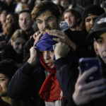 
              People react during the penalty shootout of the World Cup final soccer match between France and Argentina, in Marseille, southern France, Sunday, Dec. 18, 2022. (AP Photo/Daniel Cole)
            