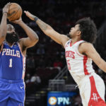 
              Philadelphia 76ers guard James Harden (1) shoots a three point basket as Houston Rockets guard Daishen Nix defends during the first half of an NBA basketball game, Monday, Dec. 5, 2022, in Houston. (AP Photo/Eric Christian Smith)
            
