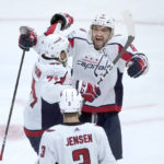 
              Washington Capitals' Alex Ovechkin, right, celebrates his 800th career goal, on a hat trick against the Chicago Blackhawks with John Carlson and Nick Jensen during the third period of an NHL hockey game Tuesday, Dec. 13, 2022, in Chicago. (AP Photo/Charles Rex Arbogast)
            