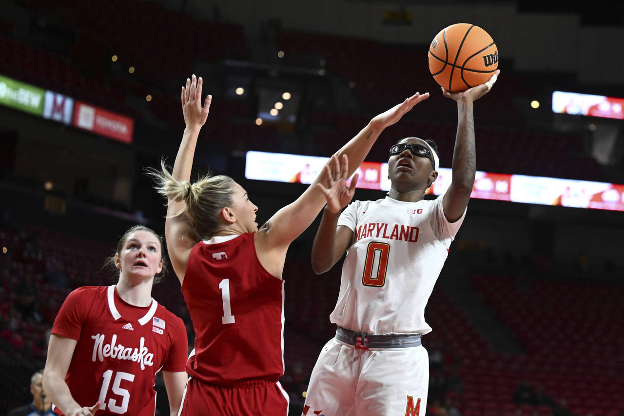 Maryland's Shyanne Sellers shoots as Nebraska's Jaz Shelley defends in the first half of an NCAA co...