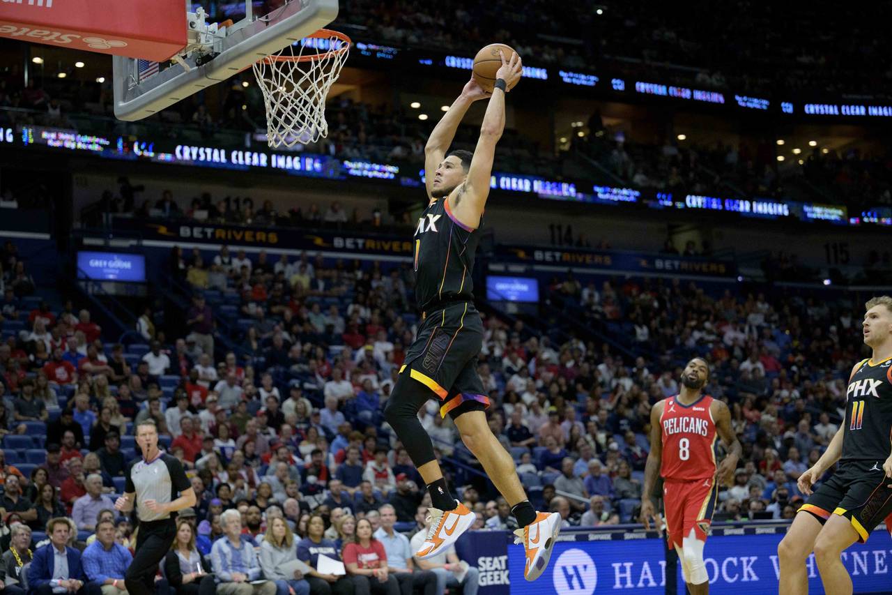 Phoenix Suns guard Devin Booker (1) goes up to dunk against the New Orleans Pelicans in the first h...