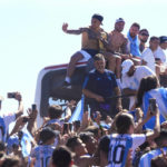 
              Argentina soccer players, from left, Leandro Paredes, Rodrigo De Paul, Lionel Messi and Nicolas Otamendi sit on the top of a bus during their team's homecoming parade after winning the World Cup tournament in Buenos Aires, Argentina, Tuesday, Dec. 20, 2022. (AP Photo/Natacha Pisarenko)
            