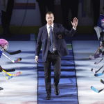 
              Former Vancouver Canucks forward Daniel Sedin waves as he walks onto the ice to be honored with other Hockey Hall of Fame inductees, his brother Henrik and former goalie Roberto Luongo, before an NHL hockey game between the Canucks and the Florida Panthers onThursday, Dec. 1, 2022, in Vancouver, British Columbia. (Darryl Dyck/The Canadian Press via AP)
            