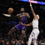 
              Los Angeles Lakers forward LeBron James (6) shoots against Denver Nuggets forward Bruce Brown, right, during the first half of an NBA basketball game in Los Angeles, Friday, Dec. 16, 2022. (AP Photo/Ashley Landis)
            