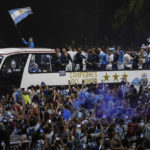 
              Soccer fans surround the bus taking Argentine soccer team that won the World Cup to the Argentina Soccer Association grounds where they will spend the night after landing at Ezeiza airport on the outskirts of Buenos Aires, Argentina, Tuesday, Dec. 20, 2022. (AP Photo/Rodrigo Abd)
            