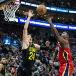 
              Utah Jazz center Walker Kessler (24) blocks a shot from New Orleans Pelicans forward Zion Williamson, right, in the second half during an NBA basketball game Tuesday, Dec. 13, 2022, in Salt Lake City. (AP Photo/Isaac Hale)
            