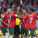 
              Referee Cesar Ramos, of Mexico, shows a yellow card to Morocco's Sofiane Boufal during the World Cup semifinal soccer match between France and Morocco at the Al Bayt Stadium in Al Khor, Qatar, Wednesday, Dec. 14, 2022. (AP Photo/Manu Fernandez)
            