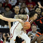 
              Oregon State forward Dzmitry Ryuny, left, reaches in for the ball as Southern California guard Tre White, center, drives to the basket with guard Dexter Akanno defending during the first half of an NCAA college basketball game in Los Angeles, Sunday, Dec. 4, 2022. (AP Photo/Alex Gallardo)
            