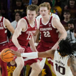 
              Arizona State guard Frankie Collins (10) keeps the ball away from Stanford guard Michael Jones (13) as Stanford guard Michael O'Connell (5) and Stanford forward James Keefe (22) look on during the second half of an NCAA college basketball game in Tempe, Ariz, Sunday, Dec. 4, 2022. Arizona State won 68-64. (AP Photo/Ross D. Franklin)
            