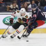 
              Chicago Blackhawks' Caleb Jones, left, and Columbus Blue Jackets' Liam Foudy skate after a loose puck during the second period of an NHL hockey game on Saturday, Dec. 31, 2022, in Columbus, Ohio. (AP Photo/Jay LaPrete)
            