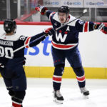 
              Washington Capitals defenseman Dmitry Orlov (9) celebrates after his goal with left wing Marcus Johansson (90) during overtime of an NHL hockey game against the Detroit Red Wings, Monday, Dec. 19, 2022, in Washington. (AP Photo/Nick Wass)
            