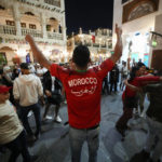 
              Moroccan soccer fans dance at the Souq Waqif during the FIFA World Cup, in Doha, Qatar, Sunday Dec. 4, 2022. (AP Photo/Ashley Landis)
            