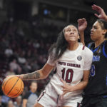
              South Carolina center Kamilla Cardoso (10) drives to the hoop against Memphis center Jada Wright, right, during the first half of an NCAA college basketball game Saturday, Dec. 3, 2022, in Columbia, S.C. South Carolina won 79-54.(AP Photo/Sean Rayford)
            
