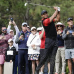 
              Tiger Woods tees off on the 4th hole during the final round of the PNC Championship golf tournament Sunday, Dec. 18, 2022, in Orlando, Fla. (AP Photo/Kevin Kolczynski)
            