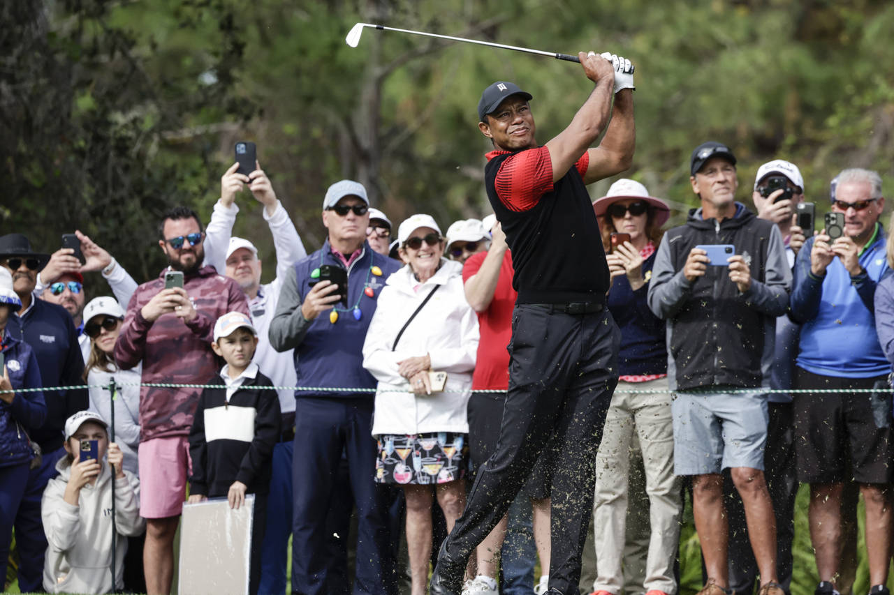 Tiger Woods tees off on the 4th hole during the final round of the PNC Championship golf tournament...