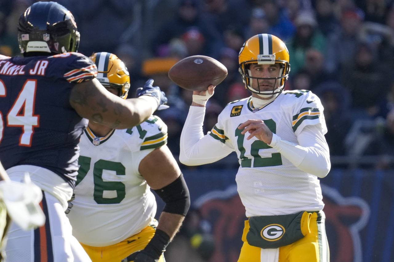 Green Bay Packers' Aaron Rodgers throws during the first half of an NFL football game against the C...