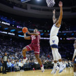 
              Oklahoma's Grant Sherfield (25) goes up for a shot against Villanova's Cam Whitmore (22) during the second half of an NCAA college basketball game, Saturday, Dec. 3, 2022, in Philadelphia. (AP Photo/Matt Slocum)
            