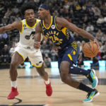 
              Indiana Pacers guard Buddy Hield (24) drives to the basket as Utah Jazz guard Collin Sexton (2) defends during the first half of an NBA basketball game Friday, Dec. 2, 2022, in Salt Lake City. (AP Photo/Rick Bowmer)
            