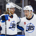 
              Winnipeg Jets forward Kyle Connor, left, celebrates his goal against the Edmonton Oilers with Neal Pionk during the third period of an NHL hockey game Saturday, Dec. 31, 2022, in Edmonton, Alberta. (Jeff McIntosh/The Canadian Press via AP)
            