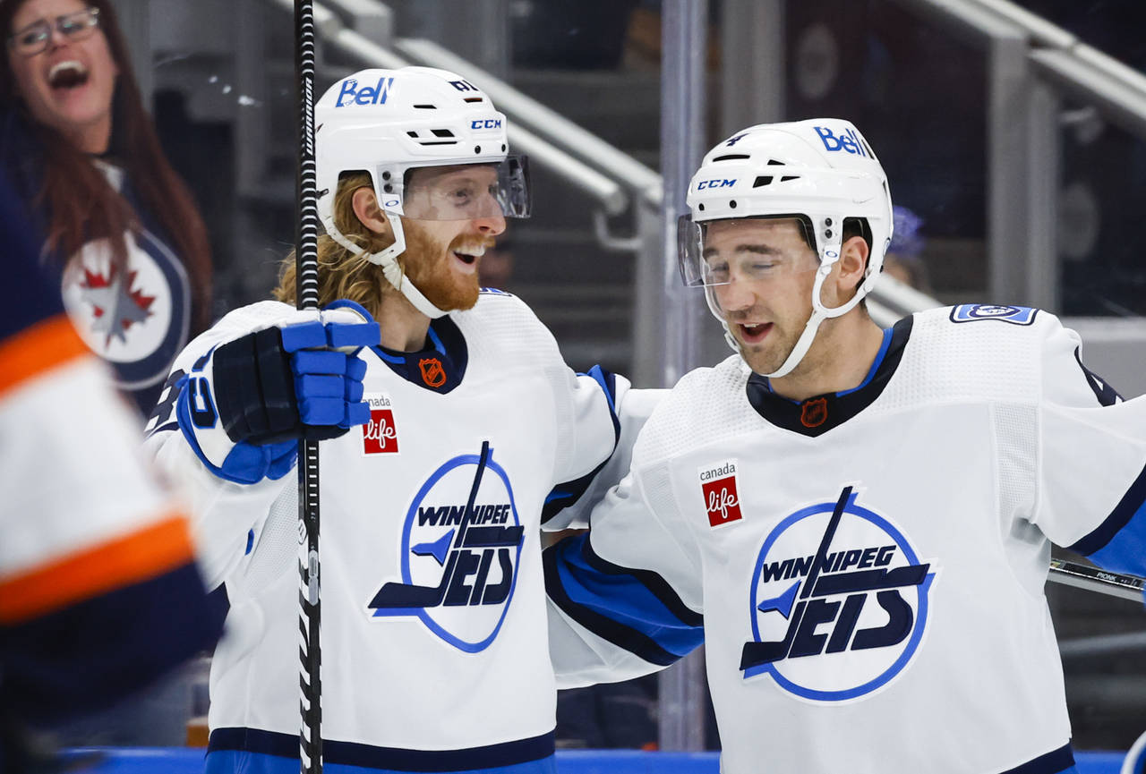 Winnipeg Jets forward Kyle Connor, left, celebrates his goal against the Edmonton Oilers with Neal ...