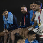 
              Captain Lionel Messi, send from left, sits with Angel de Maria, second from right, and Nicolas Otamendi, right, atop of a bus driving the players from the Argentine soccer team that won the World Cup after they landed at Ezeiza airport on the outskirts of Buenos Aires, Argentina, Tuesday, Dec. 20, 2022. (AP Photo/Rodrigo Abd)
            