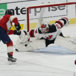 
              Florida Panthers center Eric Staal (12) makes a shot as New Jersey Devils goaltender Mackenzie Blackwood (29) defends the goal during first period of an NHL hockey game, Wednesday, Dec. 21, 2022, in Sunrise, Fla. (AP Photo/Marta Lavandier)
            