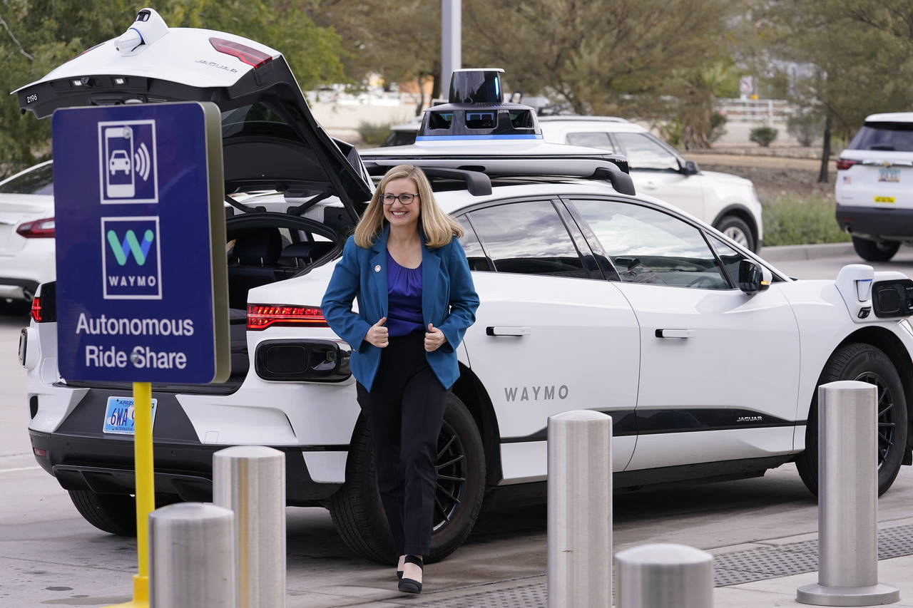 Phoenix Mayor Kate Gallego arrives in a self-driving vehicle, Friday, Dec. 16, 2022, at the Sky Har...