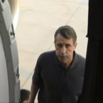 
              In this image taken from video provided by the RU-24 Russian Television on Friday, Dec. 9, 2022, Russian citizen Viktor Bout, right, who was exchanged for U.S. basketball player Brittney Griner, boards a Russian plane after a swap, in the airport of Abu Dhabi, United Arab Emirates. Russian arms dealer Bout, who was released from U.S. prison in exchange for WNBA star Griner, is widely labeled abroad as the "Merchant of Death" who fueled some of the world's worst conflicts but seen at home as a swashbuckling businessman unjustly imprisoned after an overly aggressive U.S. sting operation. (RU-24 Russian Television via AP)
            