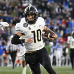 
              UCF quarterback John Rhys Plumlee (10) runs the ball during the second half of the Military Bowl NCAA college football game against Duke, Wednesday, Dec. 28, 2022, in Annapolis, Md. (AP Photo/Terrance Williams)
            
