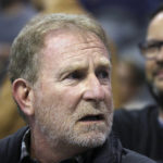 
              FILE - Phoenix Suns owner Robert Sarver watches the team play against the Memphis Grizzlies during the second half of an NBA basketball game Dec. 11, 2019, in Phoenix. Hardly a day passed in 2022 when a headline running across the ticker on ESPN would have been fitting on CNN or Fox Business. The intersection between sports and real life ranged from toxic workplace environments, alleged sexual misconduct, sportswashing, cryptocurrency, transgender sports and the COVID-19 pandemic. (AP Photo/Ross D. Franklin, File)
            