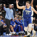 
              Wearing streets clothes, New York Knicks' Jalen Brunson, left, reacts to a call with Dallas Mavericks' Luka Doncic (77) and Dwight Powell (7) during the third quarter of an NBA basketball game in Dallas, Tuesday, Dec. 27, 2022. (AP Photo/LM Otero)
            