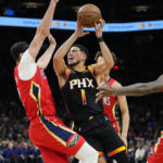 
              Phoenix Suns guard Devin Booker (1) drives against the New Orleans Pelicans during the second half of an NBA basketball game, Saturday, Dec. 17, 2022, in Phoenix. (AP Photo/Matt York)
            