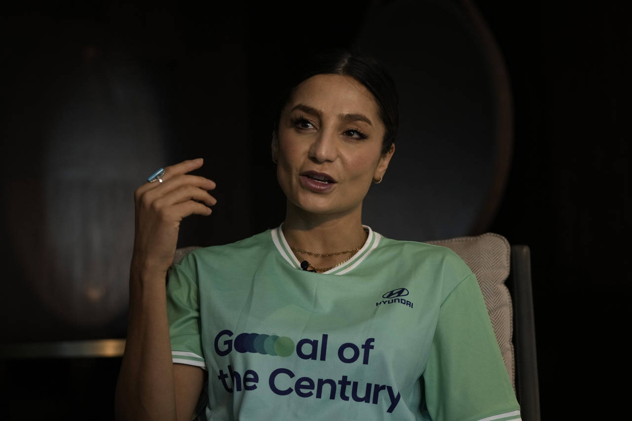 Nadia Nadim gestures as she speaks during an interview with The Associated Press in Doha, Qatar, Th...
