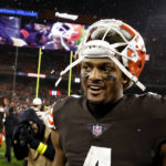 
              FILE - Cleveland Browns quarterback Deshaun Watson (4) walks off of the field after an NFL football game against the Baltimore Ravens on Saturday, Dec. 17, 2022, in Cleveland. Hardly a day passed in 2022 when a headline running across the ticker on ESPN would have been fitting on CNN or Fox Business. The intersection between sports and real life ranged from toxic workplace environments, alleged sexual misconduct, sportswashing, cryptocurrency, transgender sports and the COVID-19 pandemic. (AP Photo/Kirk Irwin, File)
            