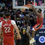 
              New Orleans Pelicans forward Zion Williamson, right, dunks against Phoenix Suns forward Torrey Craig (0) in the first half of an NBA basketball game in New Orleans, Friday, Dec. 9, 2022. (AP Photo/Matthew Hinton)
            