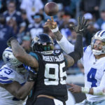 
              Dallas Cowboys quarterback Dak Prescott (4) throws an interception pass during overtime in an NFL football game against Jacksonville Jaguars, Sunday, Dec. 18, 2022, in Jacksonville, Fla. (AP Photo/Phelan M. Ebenhack)
            