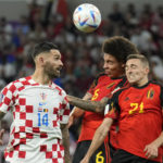 
              Croatia's Marko Livaja, left, duels for the ball with Belgium's Axel Witsel, center, and Belgium's Timothy Castagne during the World Cup group F soccer match between Croatia and Belgium at the Ahmad Bin Ali Stadium in Al Rayyan, Qatar, Thursday, Dec. 1, 2022. (AP Photo/Francisco Seco)
            