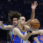 
              Oklahoma City Thunder forward Aleksej Pokusevski (17) grabs a rebound against Cleveland Cavaliers center Robin Lopez, left, during the first half of an NBA basketball game, Saturday, Dec. 10, 2022, in Cleveland. (AP Photo/Ron Schwane)
            