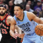 
              Memphis Grizzlies guard Desmond Bane (22) protects the ball from Toronto Raptors guard Gary Trent Jr. (33) during the first half of an NBA basketball game Thursday, Dec. 29, 2022, in Toronto. (Frank Gunn/The Canadian Press via AP)
            