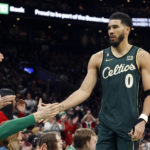 
              Boston Celtics forward Jayson Tatum (0) is congratulated by teammates as he comes out of the game late in the second half of an NBA basketball game against the Milwaukee Bucks, Sunday, Dec. 25, 2022, in Boston. (AP Photo/Mary Schwalm)
            