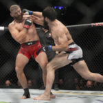 
              Magomed Ankalaev lands a right to Jan Blachowicz during a UFC 282 mixed martial arts light heavyweight title bout Saturday, Dec. 10, 2022, in Las Vegas. (AP Photo/John Locher)
            